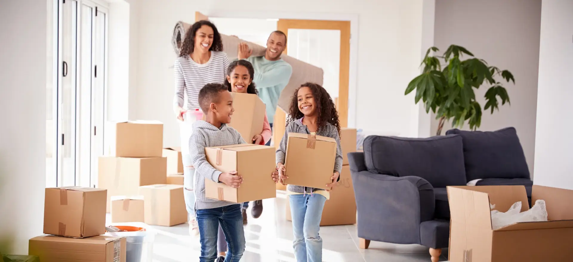 Happy family moving in to their new home thanks to EXAMPLE WEBSITE - NOT A REAL MORTGAGE COMPANY